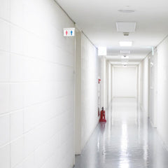 Luz de emergencia permanente con pictograma "Baños"